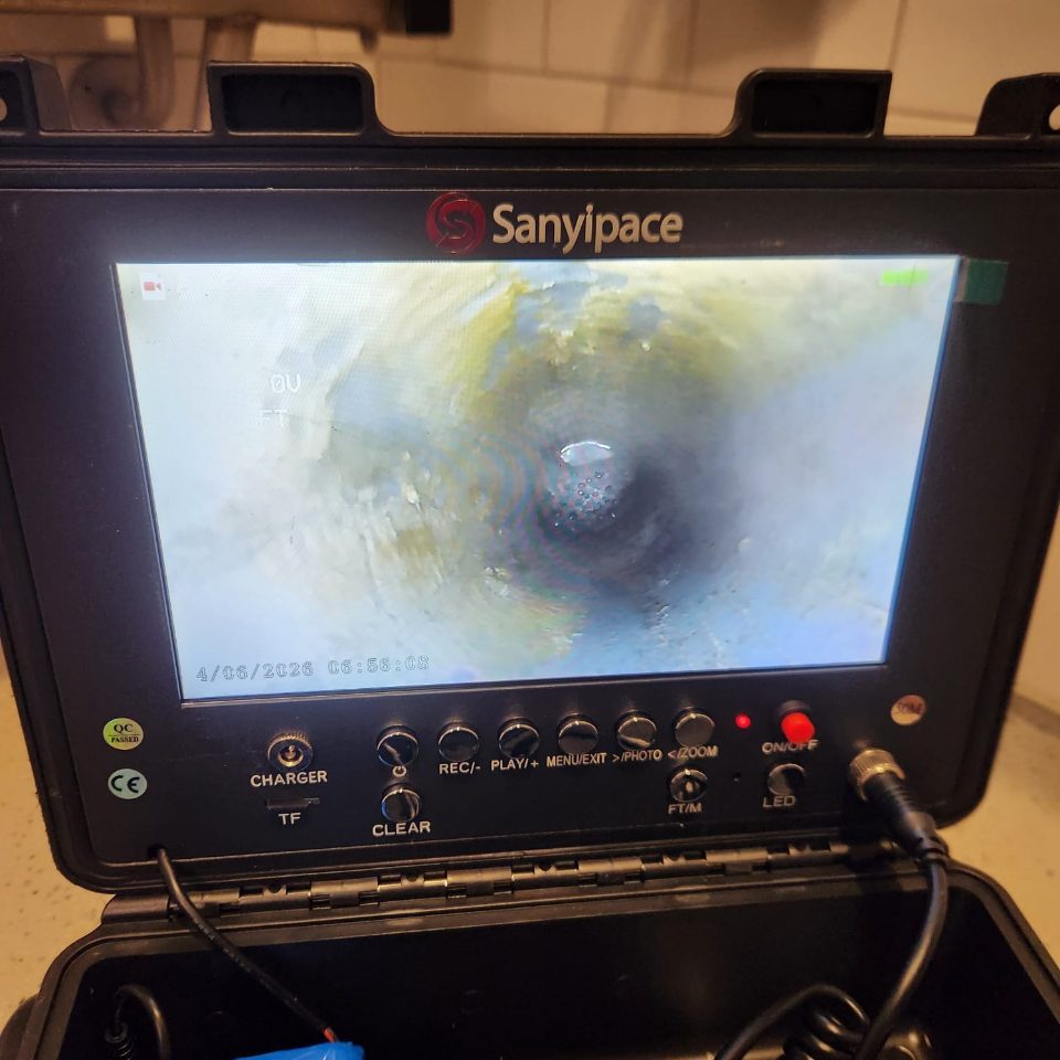 Live sewer camera monitor showing the inside of a drain pipe during inspection
